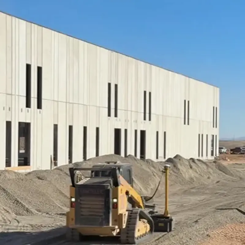 Bulldozer working near large industrial building