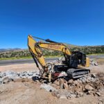 Heavy machinery digging near a road