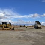 Bulldozer and dump truck working at construction site