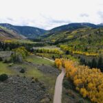 Aerial view of winding road through autumn valley