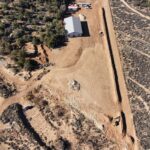 Aerial view of rural property with dirt driveway