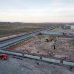 Aerial desert construction site with heavy equipment