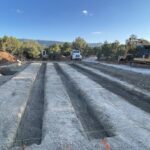Construction site with parallel excavation trenches