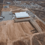 Aerial warehouse construction site with cleared lot