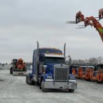 Blue semi truck in snowy equipment yard