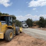 Construction vehicles on rural gravel road