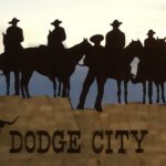 Silhouetted cowboys on horses above Dodge City