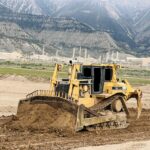 Caterpillar bulldozer pushing dirt at construction site