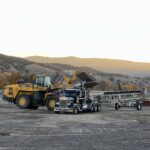 Wheel loader loading semi truck at construction site
